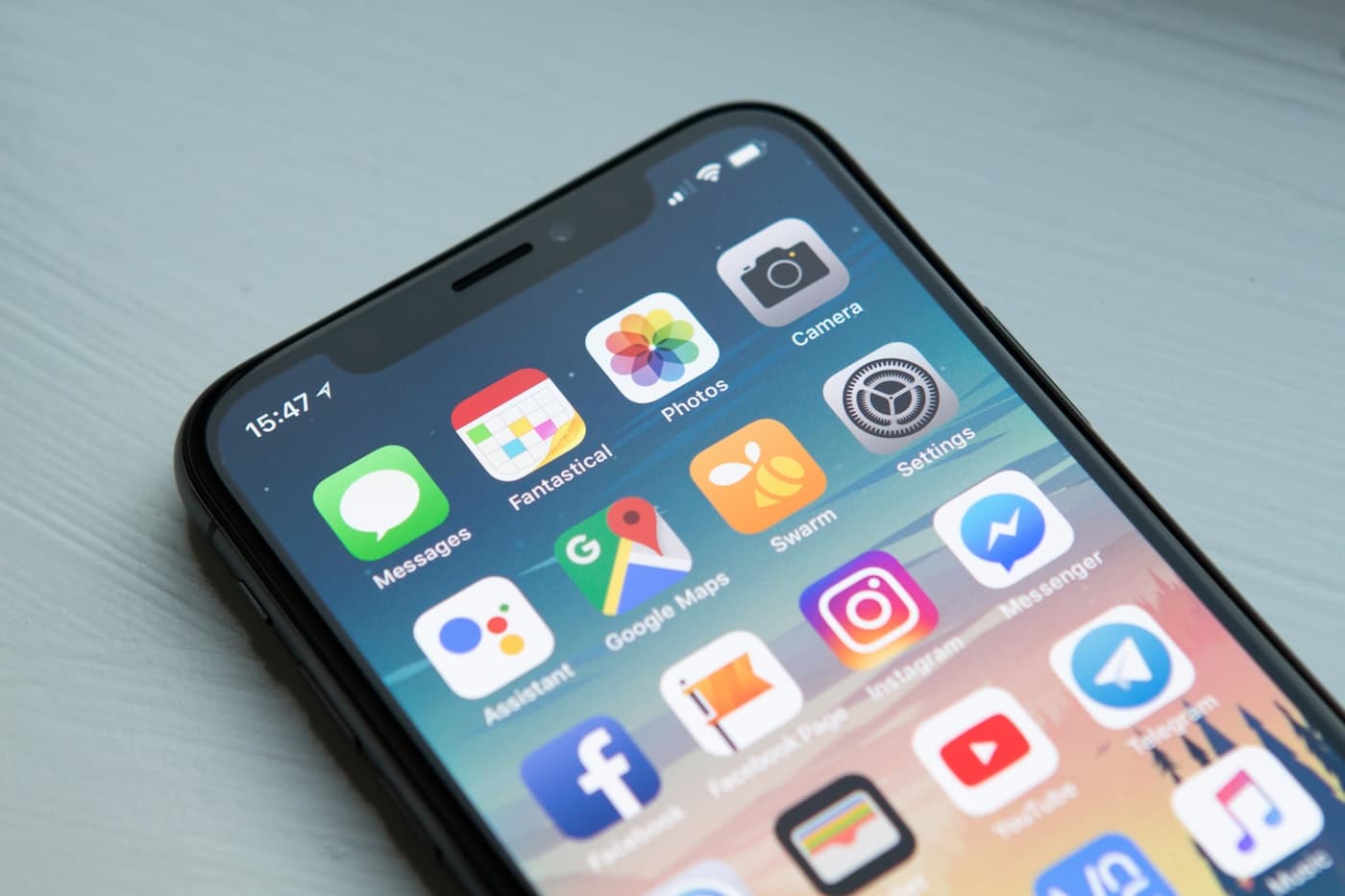 Hands holding a phone, using a digital product.